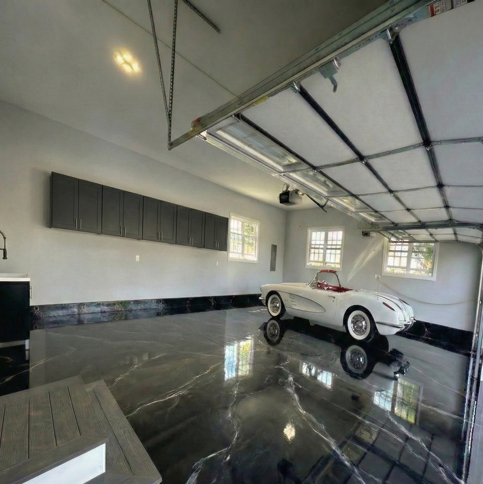 Black metallic garage with coordinated cabinets by PGC
